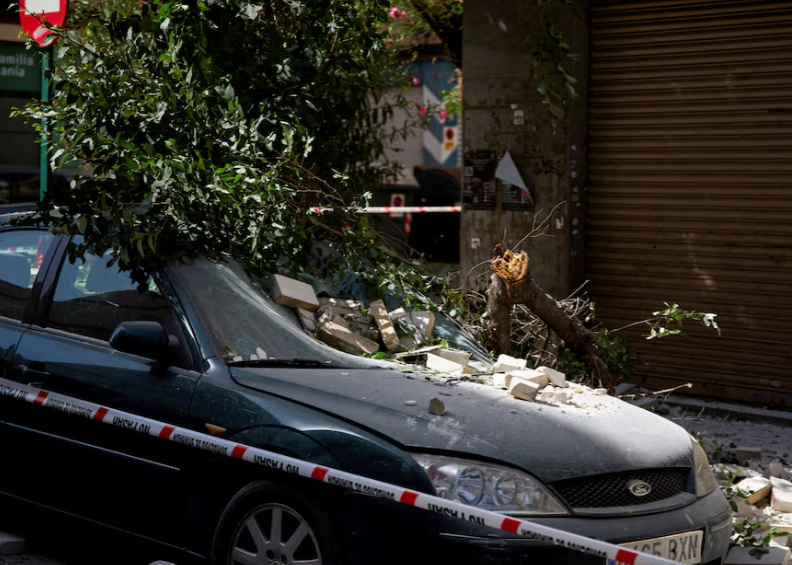 A vehicle damaged by falling masonry in Granada following the earthquake